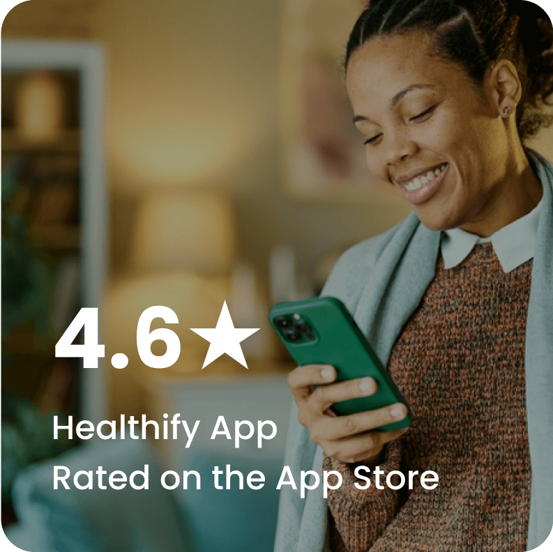 A women smiling and looking at the phone with text on image saying "4.6★ Healthify App Rated on the App Store"